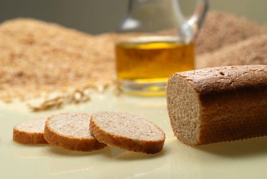 Bread with cut slices and oil and grain.