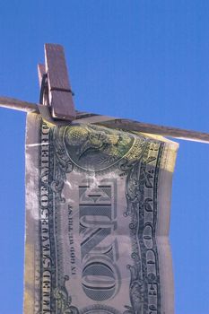 dollar bill hanging on a line