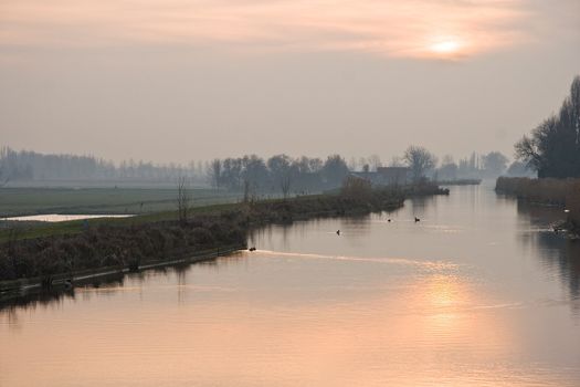 Dutch polderview on a cold and misty winter evening