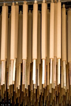 Image of joss sticks being hang dried at a factory in Malaysia.