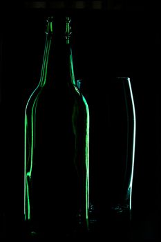 beer bottle and beer glass in the dark