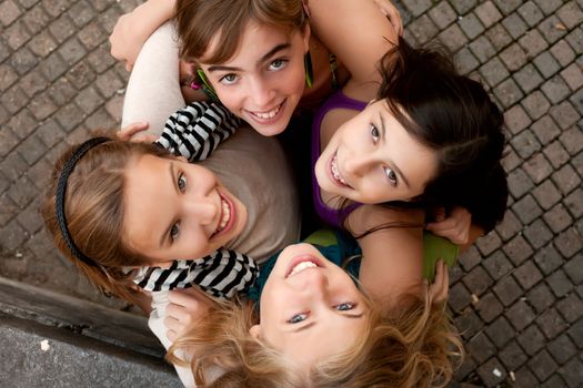 4 happy girlfriends are having a good sunny day