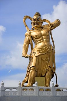 A giant statue of a guardian gurading the entrance to a Chinese temple in Malaysia.