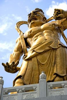 A giant statue of a guardian gurading the entrance to a Chinese temple in Malaysia.