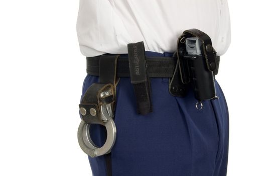 belt of a police officer with handcuffs and pepperspray on white