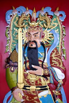 Image of a deity on a Chinese temple door.