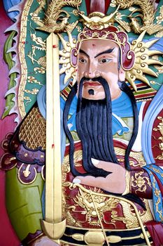 Image of a deity on a Chinese temple door.