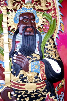 Image of a deity on a Chinese temple door.