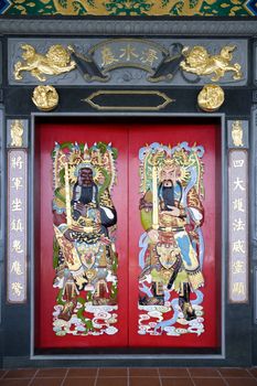 Image of Chinese temple doors with very colourful guardian deities.