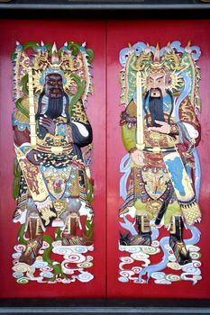 Image of Chinese temple doors with very colourful guardian deities.