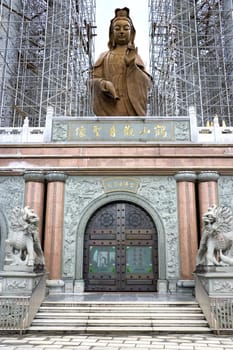 Image of a massive Chinese temple with a giant Goddess of Mercy Statue under construction in Malaysia.