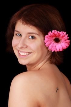 caucasian woman with pink gerber flower on hair