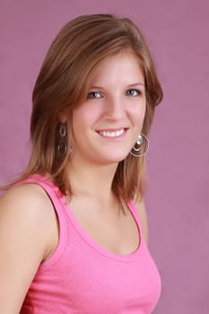 portrait of a young caucasian woman, pink background