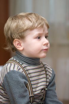 Cute little boy with blue eyes looking forward