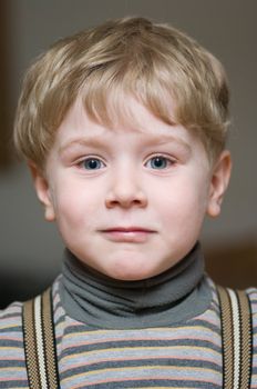 Cute little boy with blue eyes looking forward