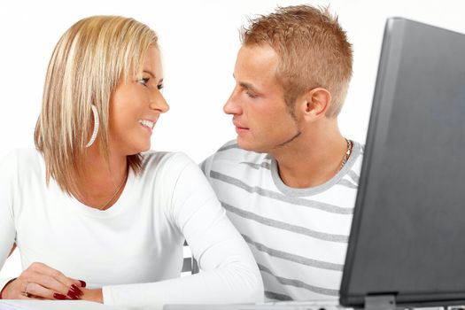 Portrait of a happy couple working with laptop in home or office