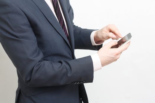 A business man typing on cell phone