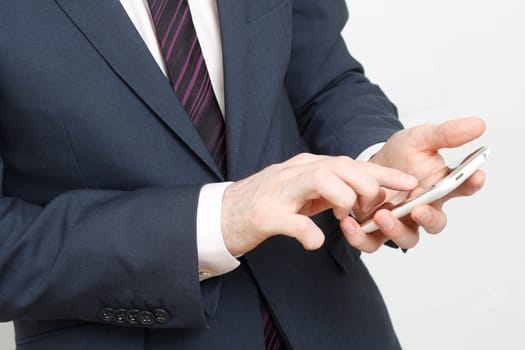 A business man typing on cell phone