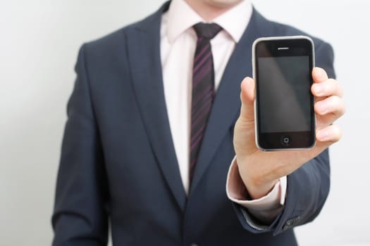 A business man showing his phone