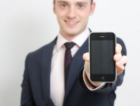 A business man showing his phone