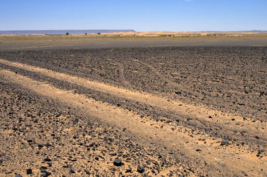 Trail in the sand and rocks Sahara desert - best of Morocco