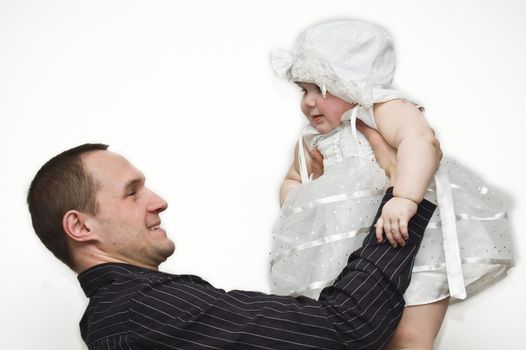 Smiling father holding his adorable babygirl in hands
