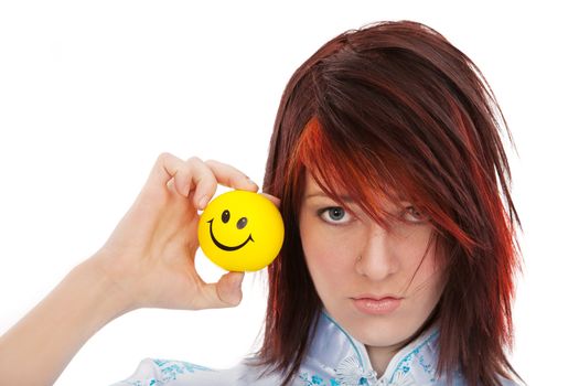 Unhappy girl holding happy smile ball