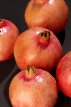 Still life of  several red ripe pomegranates