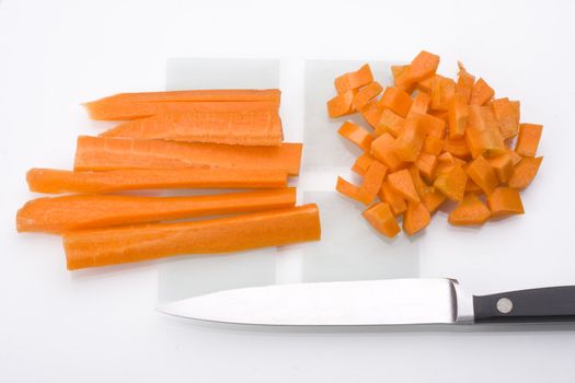 sliced carrots and a knife on a chopping board