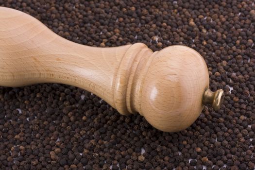 a wooden pepper mill on white background