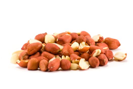 A small pile of red skin peanuts on a white background