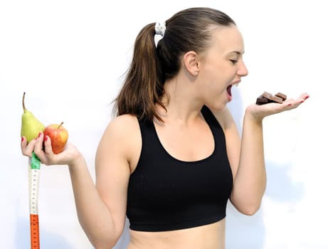 Girl holding an apple and chocolate