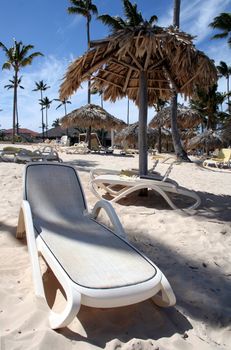 A bunch of beach beds and huts on the beach at Punta Cana, Dominican Republic.