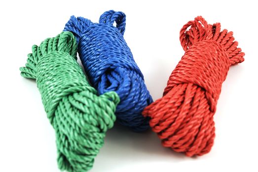 three coils of rope in green, blue and red