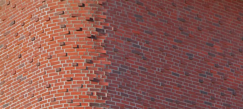 Tall red brick buidling with unusual round brick corner