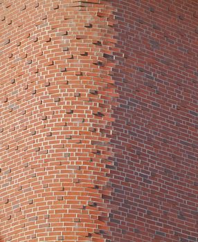 Tall red brick buidling with unusual round brick corner