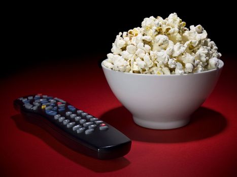 A popcorn bowl and a remote control ready for fun.