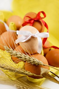 Eggs with red and white baw and wheat, easter concept