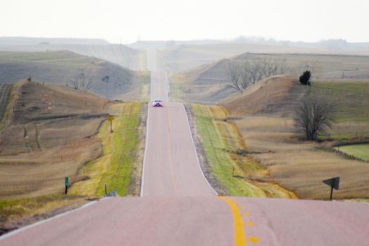 Roads in countryside surrounded by colorful fields and meadows