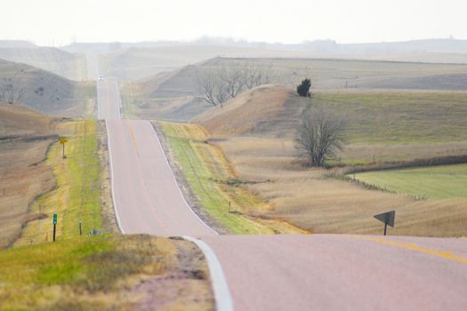 Roads in countryside surrounded by colorful fields and meadows