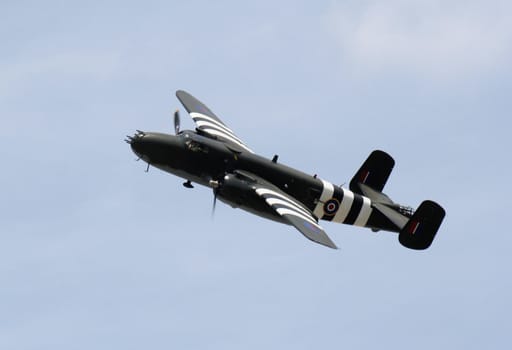 A WWII bomber soaring across the sky.