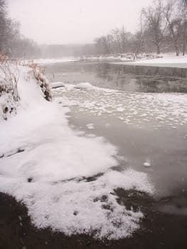 Snow falls along the Kishwaukee River on a cold winter morning at Blackhawk Springs Forest Preserve in northern Illinois.