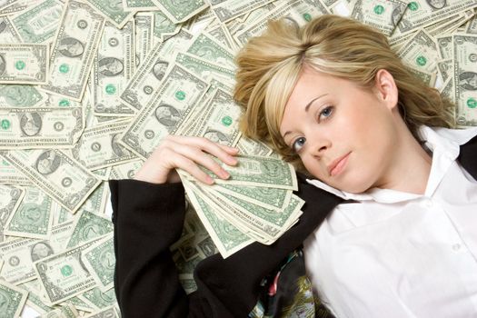 Blond woman laying in money