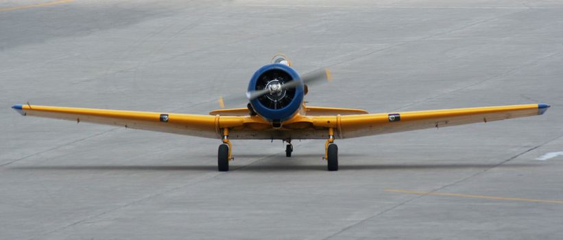 A old fighter plane landing on the runway.