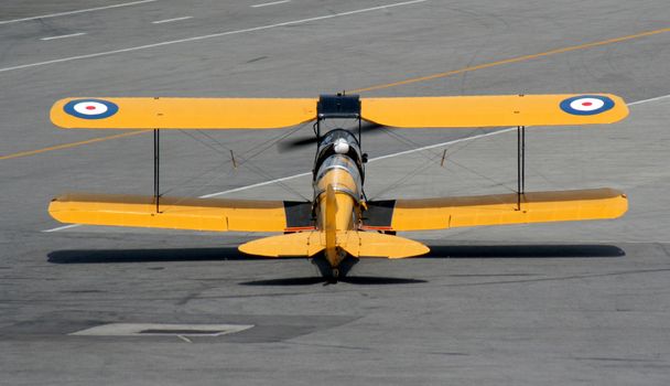 A old biplane starting it's taking off.