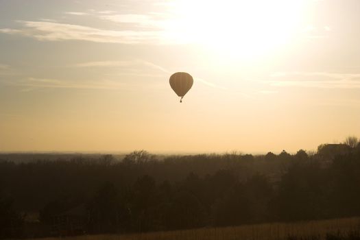 Red hot air balloon over farm fields near Omaha Nebraska