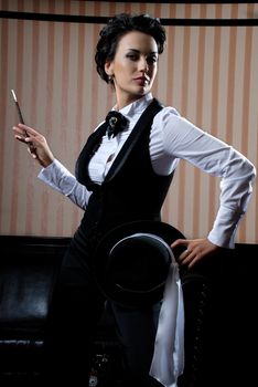 Woman on the striped background wearing business clothes, smoking.