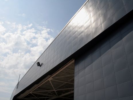 An airplane hangar cast in bright sunlight.