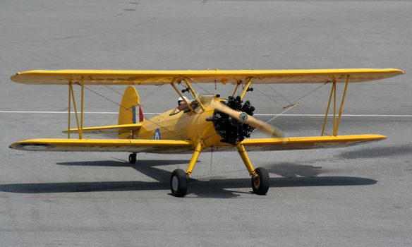 A biplane coming to rest after a flight.