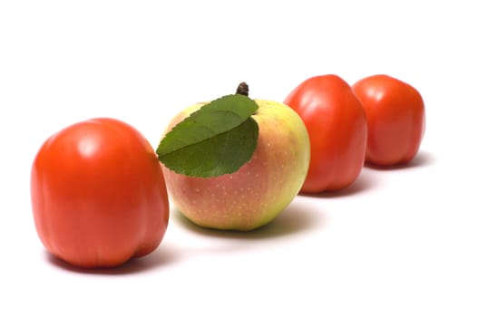 Three red tomato and apple on a white background.